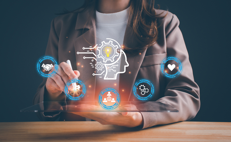 A photo of a women holding a stylus in one hand and holding out the other with illustrations of networking, puzzle pieces, and turning gears over her open hand.